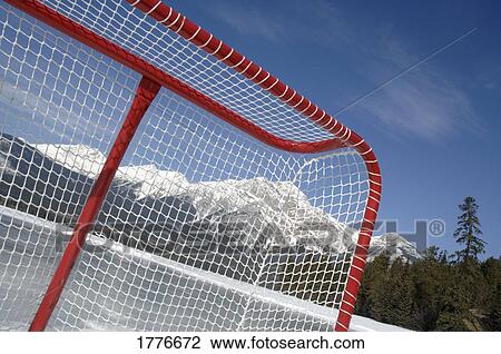 Stock Image - Hockey net against mountains. Fotosearch