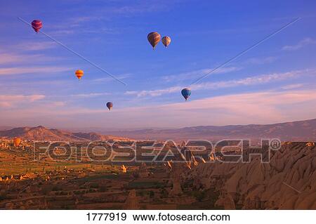 Hot air balloons floating over the badlands Cappadocia Turkey View Large Photo Image Stock Photo - Hot air balloons floating over the badlands Cappadocia Turkey. Fotosearch