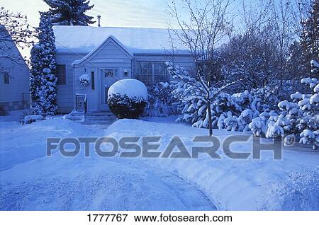 Stock Photo - House and garden covered in snow. Fotosearch