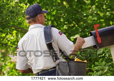 Mail being put into mailbox View Large Photo Image Stock Image - Mail being put into mailbox. Fotosearch