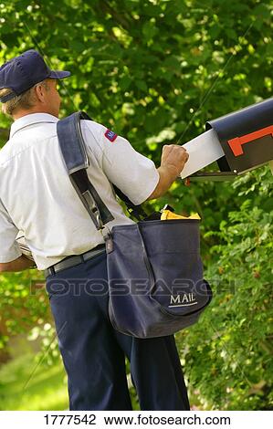 Stock Image - Mail being put into mailbox. Fotosearch