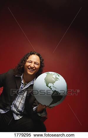 Stock Photography - Man holds the world in his hand. Fotosearch