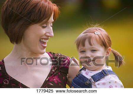 Stock Photography - Mother laughs with child. Fotosearch