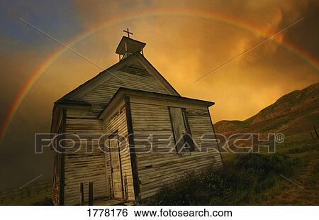 Stock Photograph - Old church with rainbow over building. Fotosearch