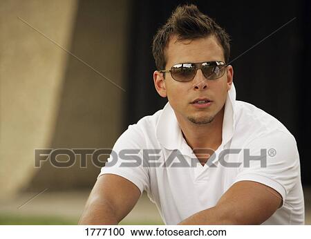 Portrait of man wearing sunglasses View Large Photo Image Stock Image - Portrait of man wearing sunglasses. Fotosearch