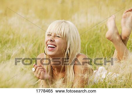 Stock Photography - Portrait of woman in grass. Fotosearch