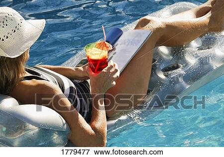 Relaxing in a pool View Large Photo Image Stock Photo - Relaxing in a pool. Fotosearch