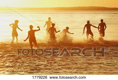 Stock Photograph - Running through the water. Fotosearch