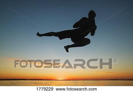 Stock Photo - Silhouette in the sunrise. Fotosearch