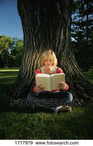 Stock Photo - Teenager reads a book. Fotosearch