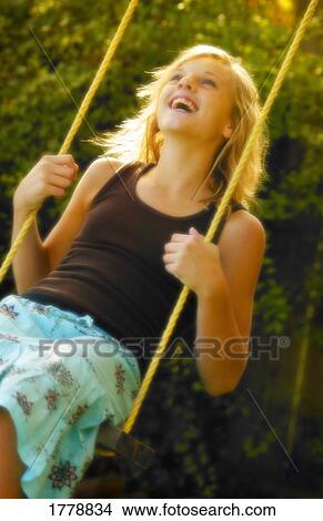 Teenager swinging on swing View Large Photo Image Picture - Teenager swinging on swing. Fotosearch