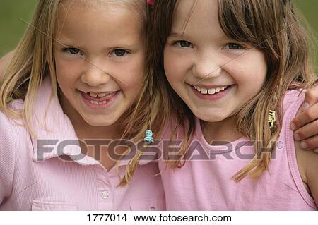Two sisters hugging View Large Photo Image Picture - Two sisters hugging. Fotosearch