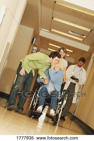 Two young adults visiting a senior woman in the hospital View Large Photo Image Stock Photography - Two young adults visiting a senior woman in the hospital. Fotosearch