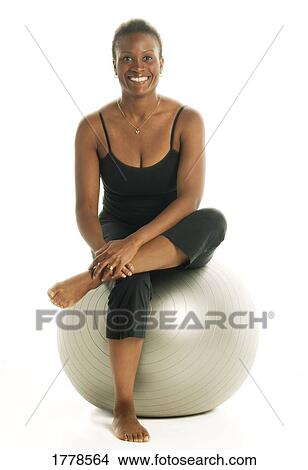 Picture - Woman on exercise ball. Fotosearch