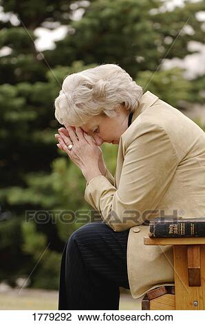 Stock Image - Woman prays. Fotosearch