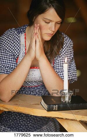 Stock Photography - Woman prays. Fotosearch
