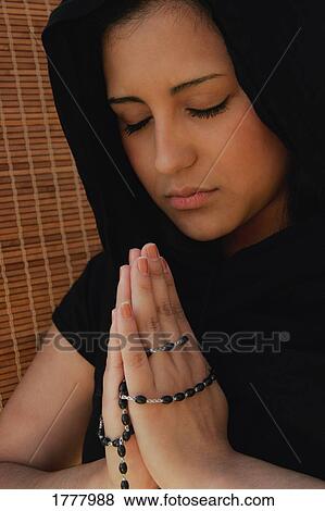 Woman prays with prayer beads View Large Photo Image Stock Photo - Woman prays with prayer beads. Fotosearch