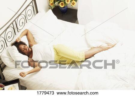 Woman sleeping in bed View Large Photo Image Stock Image - Woman sleeping in bed. Fotosearch