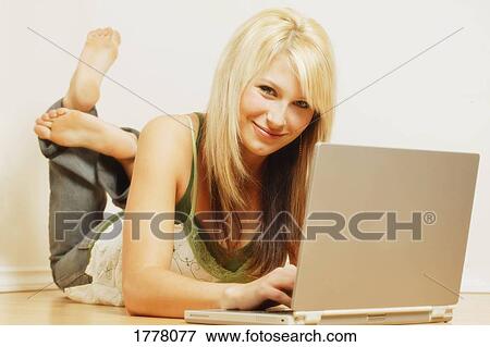 Stock Photo - Woman working on lap top. Fotosearch