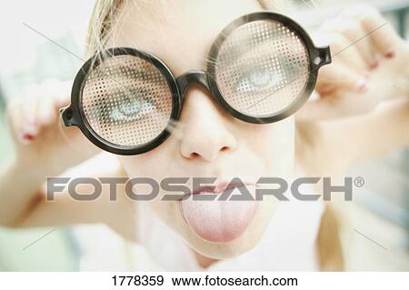 Stock Photo - Young girl sticking out tongue. Fotosearch