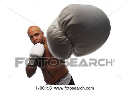 Stock Image - A boxer punches. Fotosearch