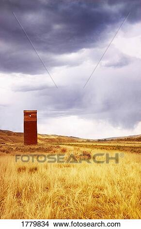 Picture - A grain elevator in a field. Fotosearch