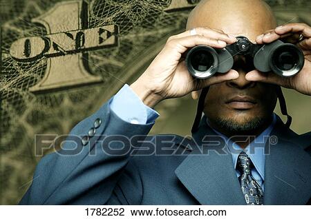 Stock Image - American dollar bill and man with binoculars. Fotosearch