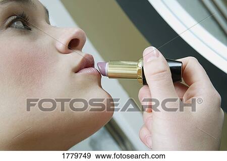 Applying lipstick View Large Photo Image Stock Photo - Applying lipstick. Fotosearch