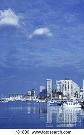 Stock Photograph - Boats in harbour in city. Fotosearch