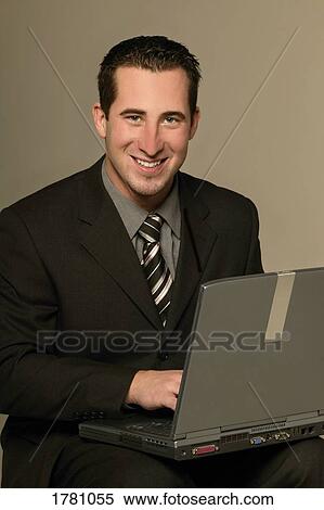 Businessman with laptop computer View Large Photo Image Stock Photography - Businessman with laptop computer. Fotosearch