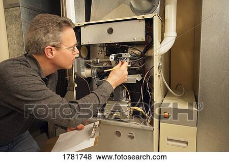 Checking the furnace View Large Photo Image Stock Photo - Checking the furnace. Fotosearch