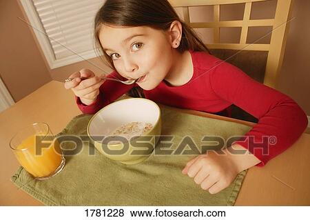 Stock Photo - Child eating breakfast. Fotosearch