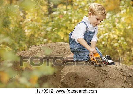Child plays by himself View Large Photo Image Stock Image - Child plays by himself. Fotosearch