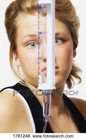 Stock Photo - Child stares at medicine. Fotosearch