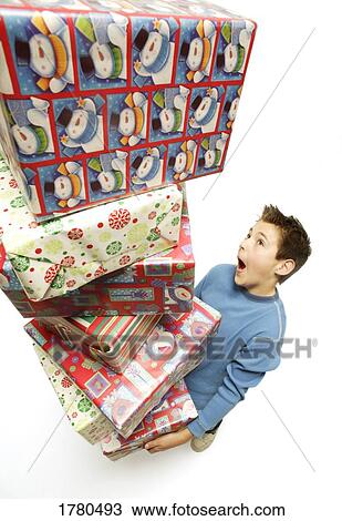 Child with a stack of presents View Large Photo Image Stock Image - Child with a stack of presents. Fotosearch