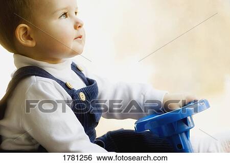 Stock Photograph - Child with steering wheel. Fotosearch
