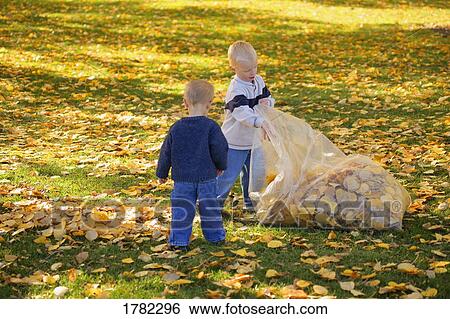 Children doing fall cleanup View Large Photo Image Stock Photograph - Children doing fall cleanup. Fotosearch