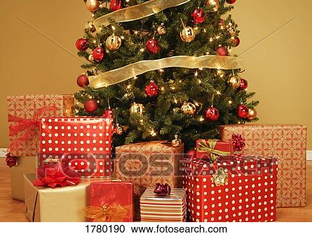 Stock Image - Christmas tree with presents underneath. Fotosearch