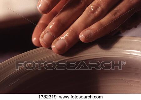 Stock Photo - Close up of pottery being shaped. Fotosearch