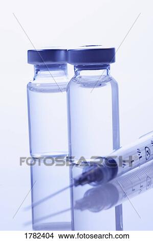 Picture - Closeup of needle and vials. Fotosearch