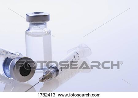 Stock Image - Closeup of syringe and vials. Fotosearch