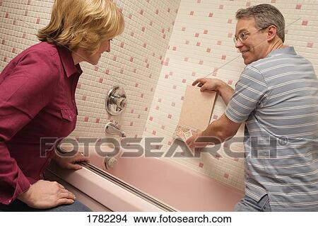 Couple choose tile for renovations View Large Photo Image Picture - Couple choose tile for renovations. Fotosearch