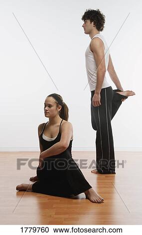 Stock Image - Couple doing stretches together. Fotosearch