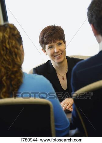 Couple in a meeting with a woman View Large Photo Image Picture - Couple in a meeting with a woman. Fotosearch