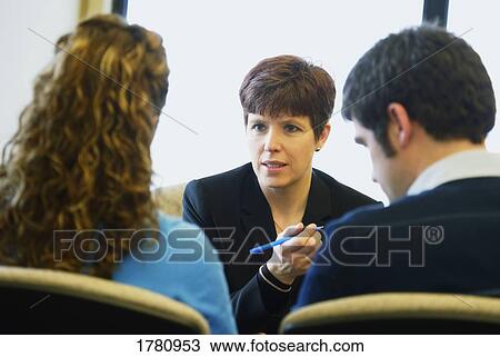 Couple in a meeting with a woman View Large Photo Image Stock Image - Couple in a meeting with a woman. Fotosearch