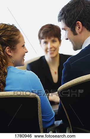 Couple in a meeting with a woman View Large Photo Image Stock Photograph - Couple in a meeting with a woman. Fotosearch