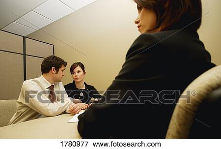 Stock Photo - Couple in a meeting with woman. Fotosearch