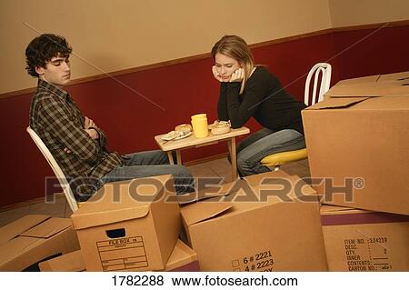 Couple living out of boxes View Large Photo Image Stock Photo - Couple living out of boxes. Fotosearch