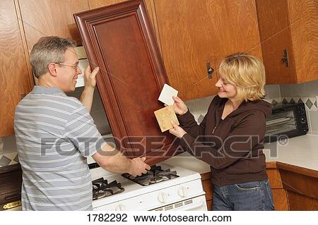 Stock Image - Couple renovating a house. Fotosearch