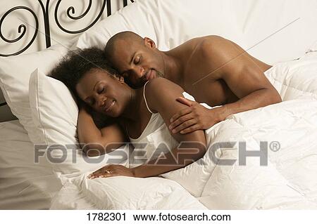 Stock Image - Couple sleeping in bed. Fotosearch